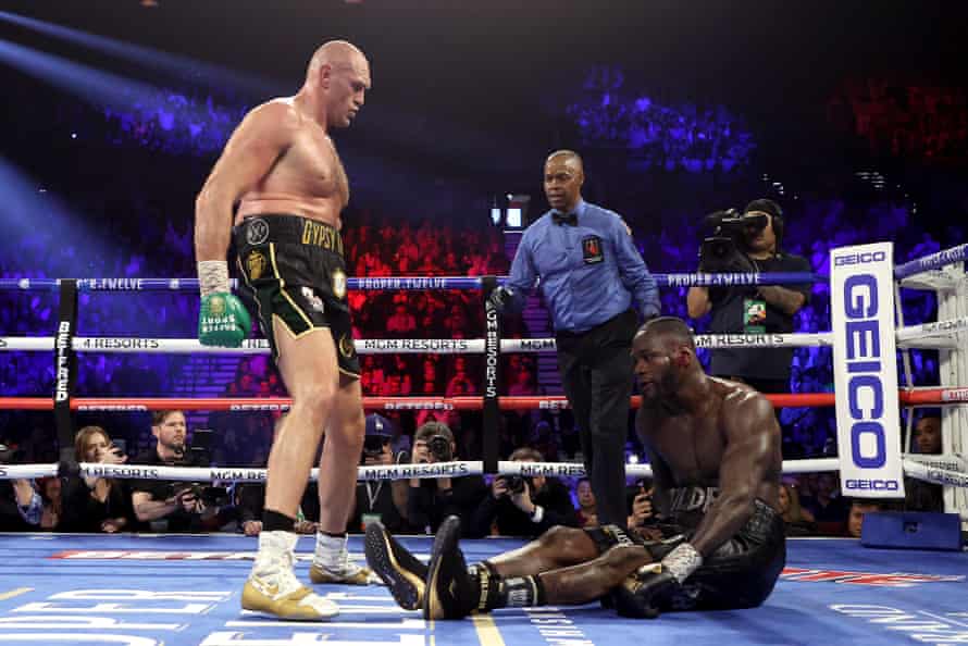 Tyson Fury knocks down Deontay Wilder in the fifth.