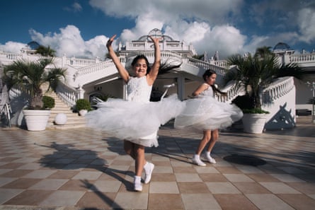 Eleonora and Giusy play and dance at the Princess Royal Palace in Telese during the party for their first communion