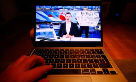 A laptop screen showing the moment Marina Ovsyannikova held her protest poster behind the Cannel One news anchor live on air