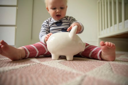 Baby holds on to a piggy bank