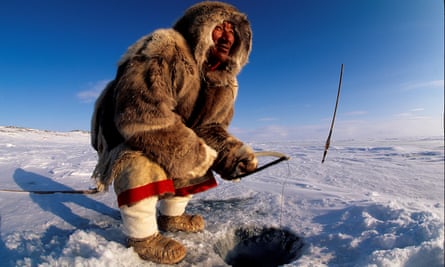 An Inuit man fishing on Baker Lake in Nunavut, Canada.
