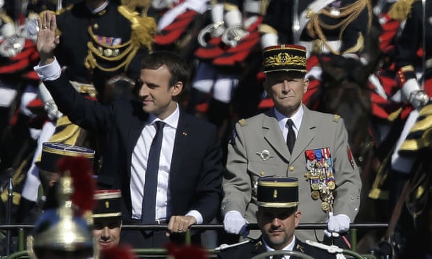Emmanuel Macron and Pierre de Villiers drive down the Champs Elysees avenue during Bastille Day parade.