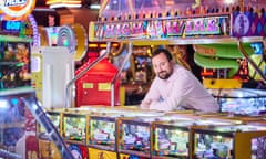 Jeremy Godden amid bright lights of arcade.