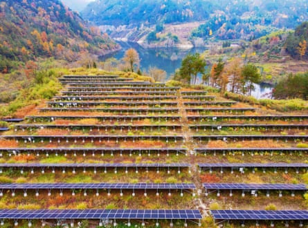 Rows of photovoltaic panels are installed on a barren hill in Pingjing village in Anqing, China, last November
