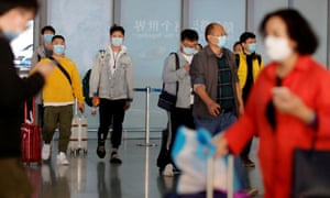 Coronavirus live news: France to ease lockdown as global deaths pass 1.4m | World news 1 People wearing protective face masks against the coronavirus arrive at Capital Airport in Beijing, China, 5 November 2020.