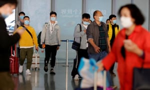 People wearing protective face masks against the coronavirus arrive at Capital Airport in Beijing, China, 5 November 2020.