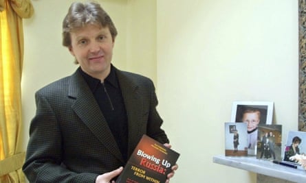Alexander Litvinenko in May 2002 holding a copy of his book Blowing Up Russia: The Return of the KGB