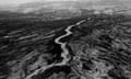 black and white overhead panorama of river, road and peaks