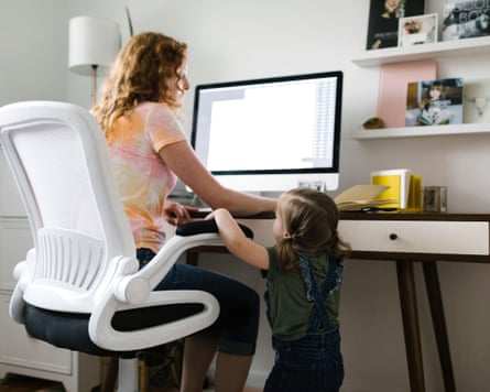 A young girl (age two or three) interrupting her mother who is working from home