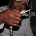 Dambimangari traditional owner Gary Umbagai holds a hatchling crocodile caught so that a tissue sample could be taken as part of a genetics study.