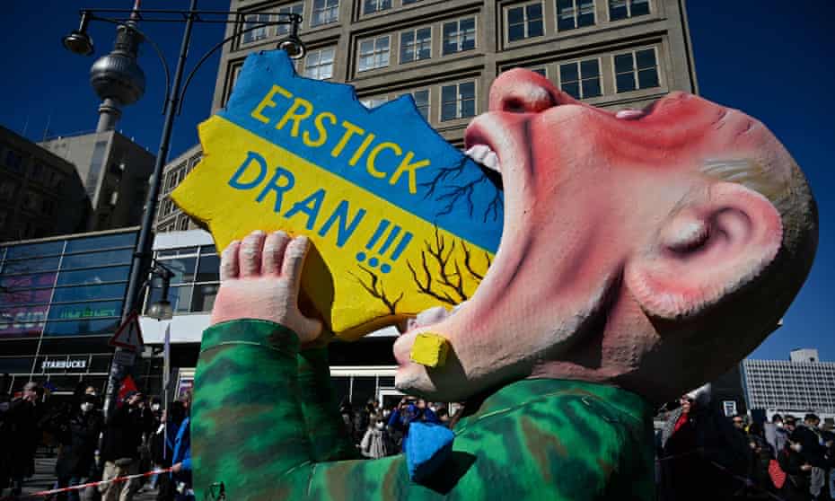 A giant figure of Vladimir Putin swallowing a map of Ukraine