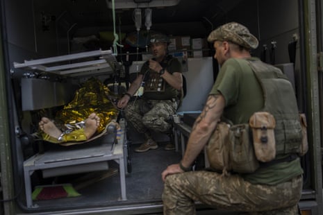 An injured Ukrainian soldier is transferred to a medical facility after emergency treatment in Bakhmut.