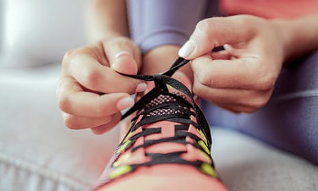 Woman tying shoelaces on running shoes