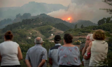 Smoke billows from a forest fire near Montaña Alta