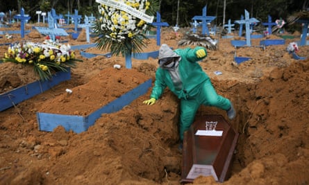 A gravedigger works during a funeral in Manaus, Brazil, which has one the continent’s deadliest outbreaks.