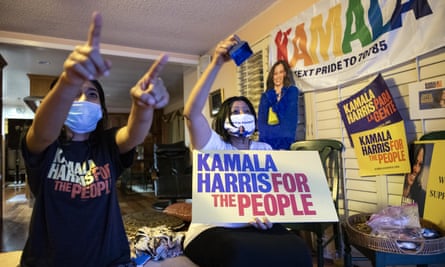 Harini Krishnan, right, and her daughter Johnny Krishnan celebrating with a poster promoting Jha Kamala Harris