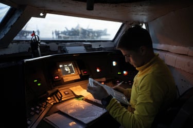 Brody Samaha, a “shooter”, sits in the Integrated Catapult Control System bubble as he launches a fighter jet during morning operations.