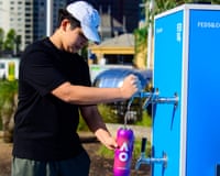 Charlie fills his water bottle at a free water station in Federation Square in Melbourne, Tuesday, January 27, 2026. Victorians are sweating through what could be the state's most severe heatwave in nearly two decades, (AAP Image/Michael Currie) NO ARCHIVING