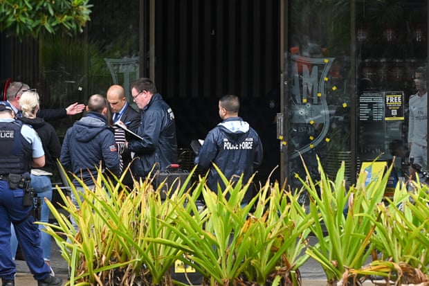 Bullet holes are seen in a window where police attend the scene of a shooting at at the Bodyfit Fitness Centre in Auburn, Sydney, Wednesday, May 11, 2022. 