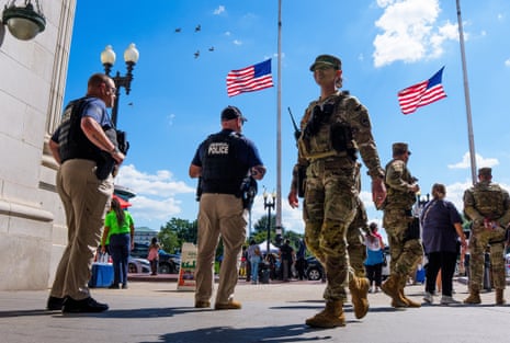 Homeland security officers and national guard patrol members outside Union Station in Washington DC, on 29 August.