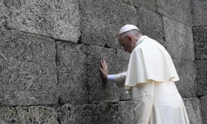 Pope Francis touches the ‘wall of death’, the scene of many thousands of executions.
