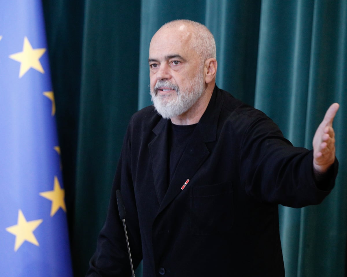 Albanian prime minister Edi Rama gestures with his hand while speaking at a podium.