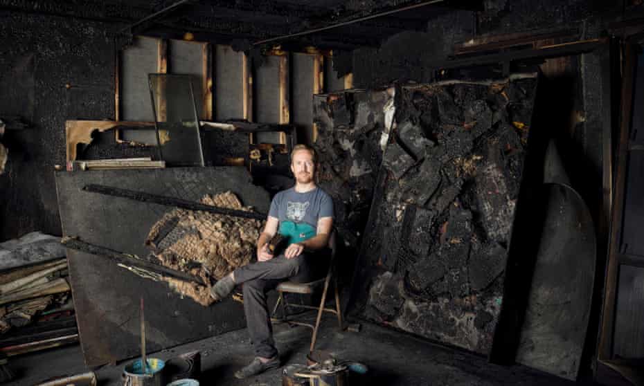 Tom de Freston sitting on a chair in his burnt-out studio