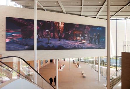 Video installation showing in an atrium of a white-walled building with windows