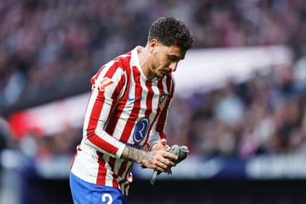 José Giménez takes an injured pigeon to safety