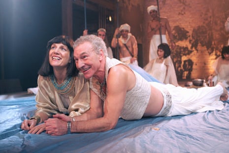 Patrick Stewart and Harriet Walter, as Antony and Cleopatra, lie smiling together onstage