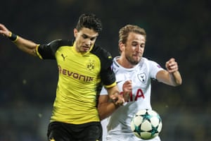 Dortmund’s Marc Bartra challenges Harry Kane.