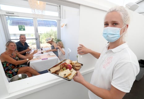 A waitress serves diners in the restaurant at the St Moritz Hotel’s socially distanced restaurant on July 21, 2020 in Wadebridge, England. This is the UK’s first purpose-built socially distanced restaurant.