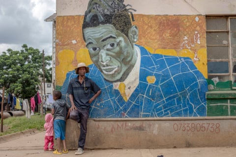 Basil Matsika in front of his mural of the late dancehall artist Soul Jah Love in Mbare, Zimbabwe.