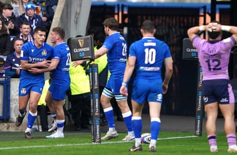 Italy's Tommaso Allan (left) celebrates his team's first try of the match with his teammates.
