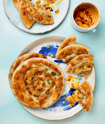 A coiled spring-onion pancake on a plate