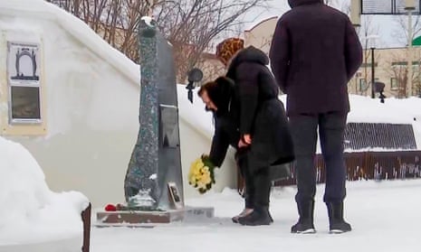 In this grab taken from video, Lyudmila Navalnaya, mother of the late Russian opposition leader Alexei Navalny, center, pays tribute to her son at the memorial to victims of political repression, in Salekhard, 1,937 km (1211 miles) northeast of Moscow, Russia, on Tuesday, Feb. 20, 2024.