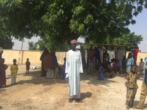 Modu Amsami stands next to a tree that he says would once have been submerged by Lake Chad