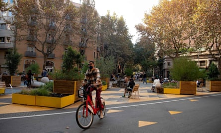 A man rides a bicycle in a pedestrian area as part of an expansion of the ‘superilla’ (superblock) plan promoting cycling and car-free zones in Barcelona.