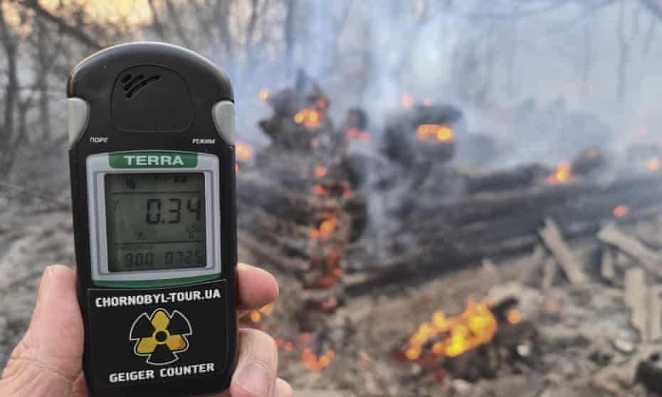 A Geiger counter shows increased radiation level at the forest fire near Chernobyl.