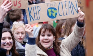 People holding placards take part in a demonstration against climate change in Brussels, Belgium,