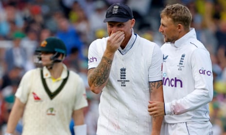 England's captain Ben Stokes (centre) tries to suppress a laugh as he celebrates with Joe Root after Root dismissed Australia's Cameron Green for a duck on day one of the second Ashes Test at Lord's on June 28, 2023.