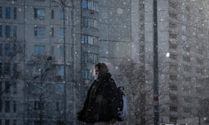 A woman wearing a face mask during snowfall in Moscow yesterday.