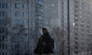 Covid live: WHO director says Europe is again centre of pandemic with France and Netherlands set for new measures 4 A woman wearing a face mask during snowfall in Moscow yesterday.