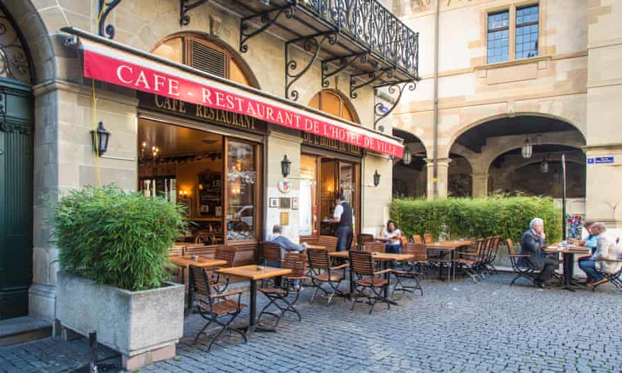 A cafe and the town hall in Old Town, Geneva, Switzerland.