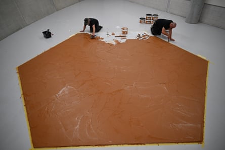 An aerial view of the men about to finish off the giant hexagon of peanut butter