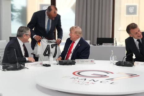 German chancellor Friedrich Merz presents US President Donald Trump with a jersey with the number 47 on it as British prime minister Keir Starmer and the president of France, Emmanuel Macron, look on