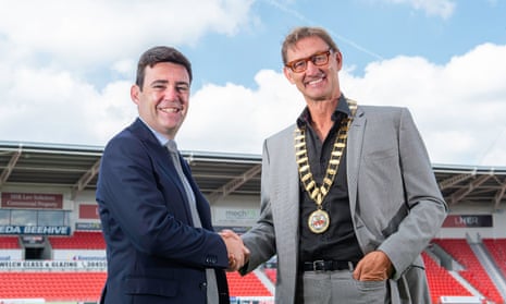 Andy Burnham hands the presidential chains of the Rugby Football League over to Tony Adams