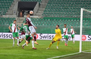 Andriy Yarmolenko rises to head home the opening goal in Vienna.