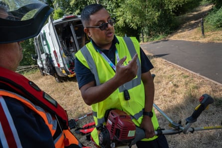 Mo Ghatnoor helps a first time member with a strimmer.