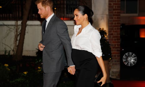 Prince Harry and Meghan hold hands on their way to an awards ceremony